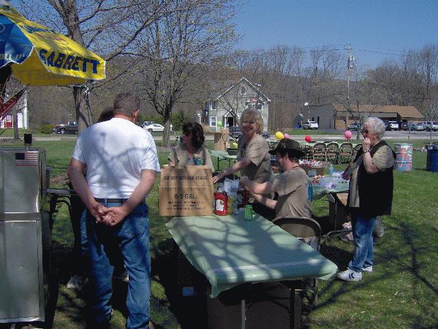 Volunteers Supplying Condiments and Hot Dogs